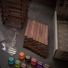 Load image into Gallery viewer, Topsy Timbers - The Incredibly Entertaining, Addictive, & Competitive Tower Building Game Designed & Manufactured from Aromatic Cedar in Our Los Angeles Workshop. Fun for the whole family with elements of chance and sabotauge! The boss went home early leaving you and the crew to manage the timberyard. Grab the keys to the crane, it's time to have some fun... Build a taller tower than your friends before the timberyard runs dry!